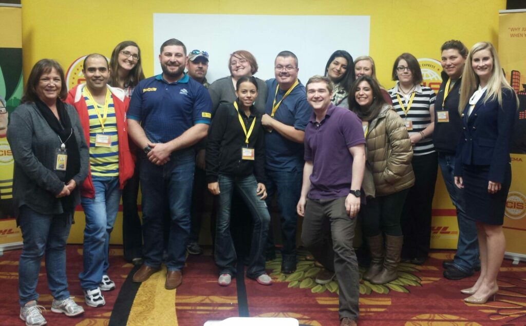 Photo of Dr. Rea Prado with former co-workers at DHL