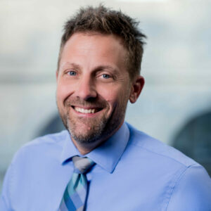 Ryan Tobiasz sits in front of a blurred background