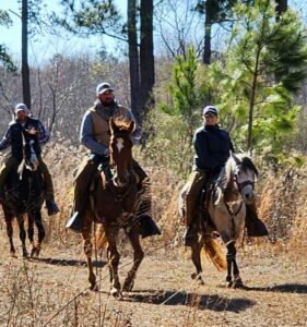 Photo of Heather and her husband Doug horseback riding.