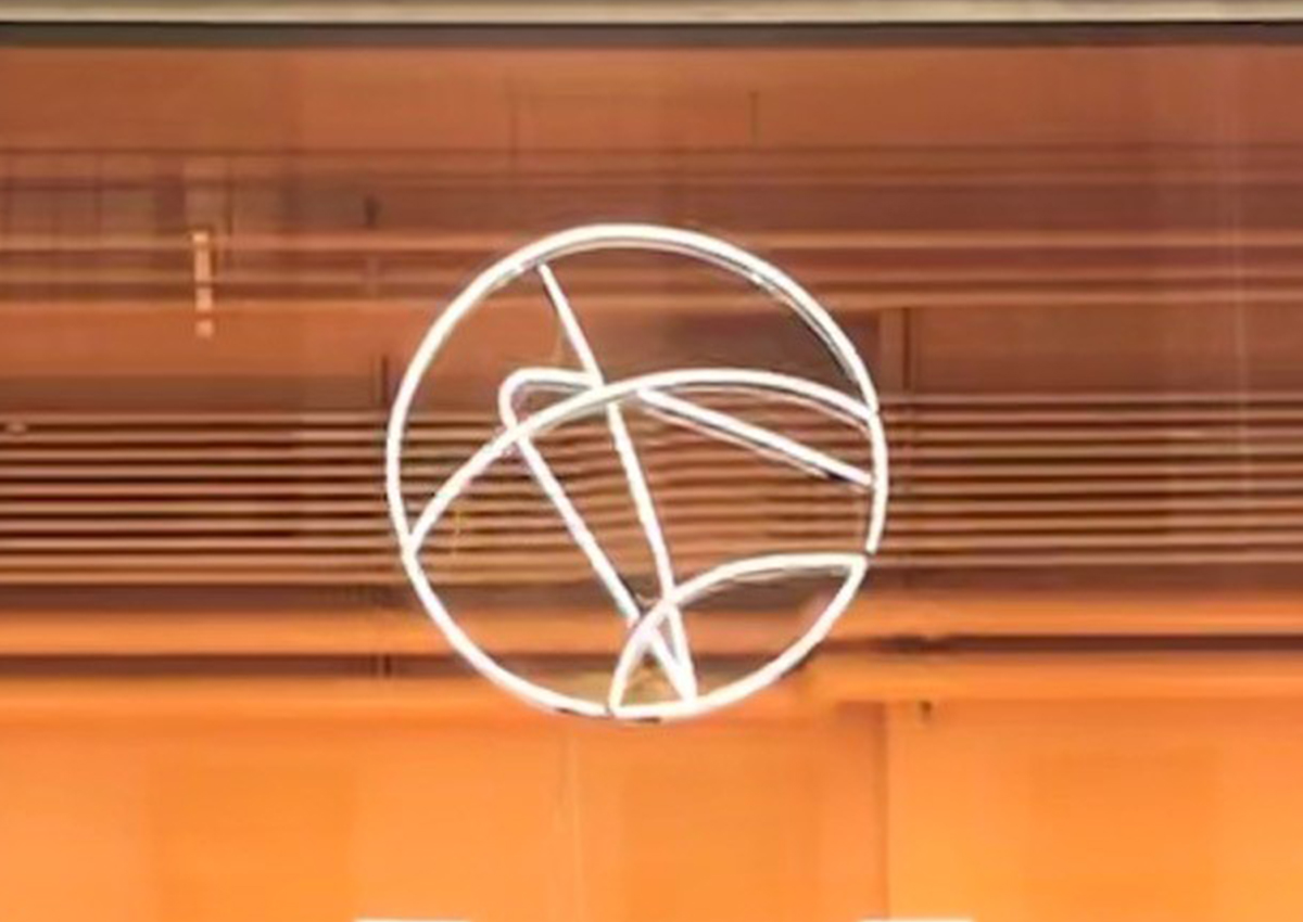 Orange background with white Adler logo in fluorescent light