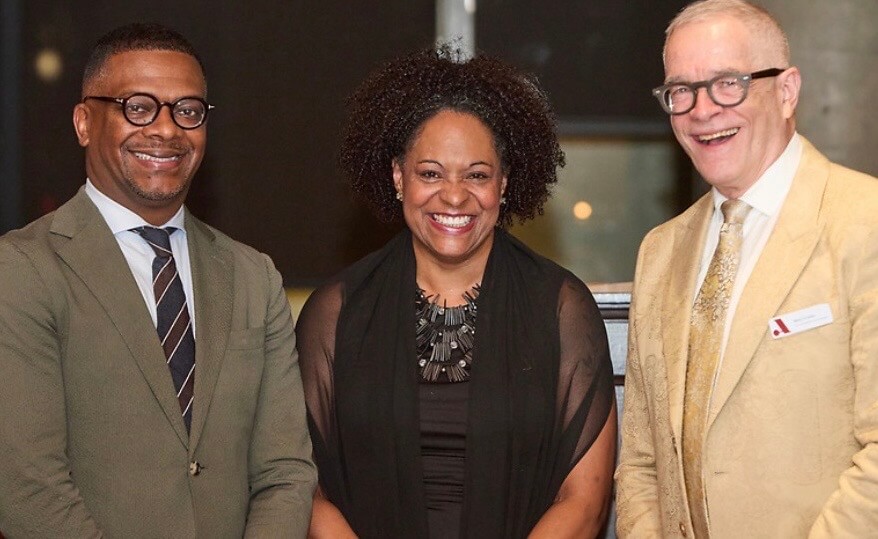 Three Adler University executive leadership members smiling and posing for a photo.